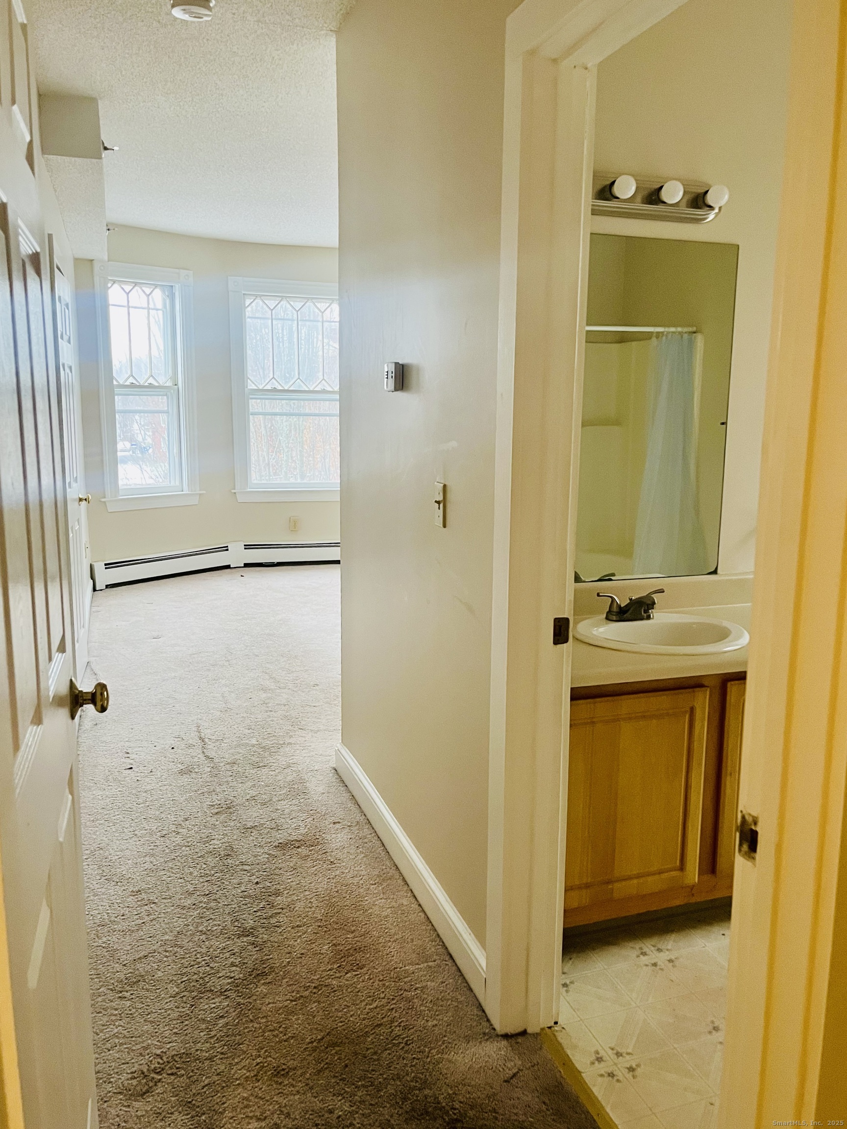 24 Mortson Street Hartford, CT 06106 - Photo 8 of 16 a bathroom with a sink a mirror and a shower