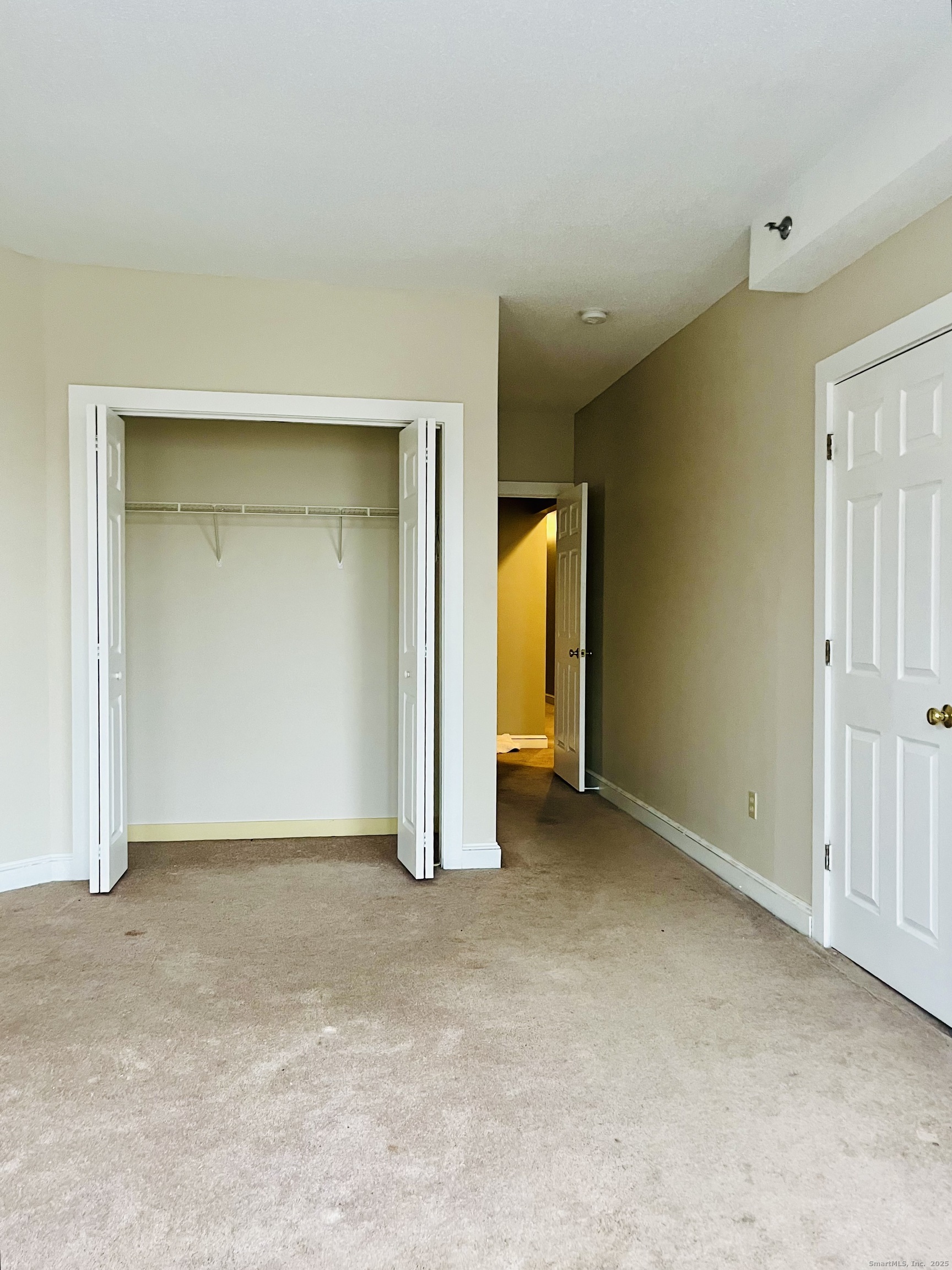 24 Mortson Street Hartford, CT 06106 - Photo 10 of 16 an empty room with a mirror and a window