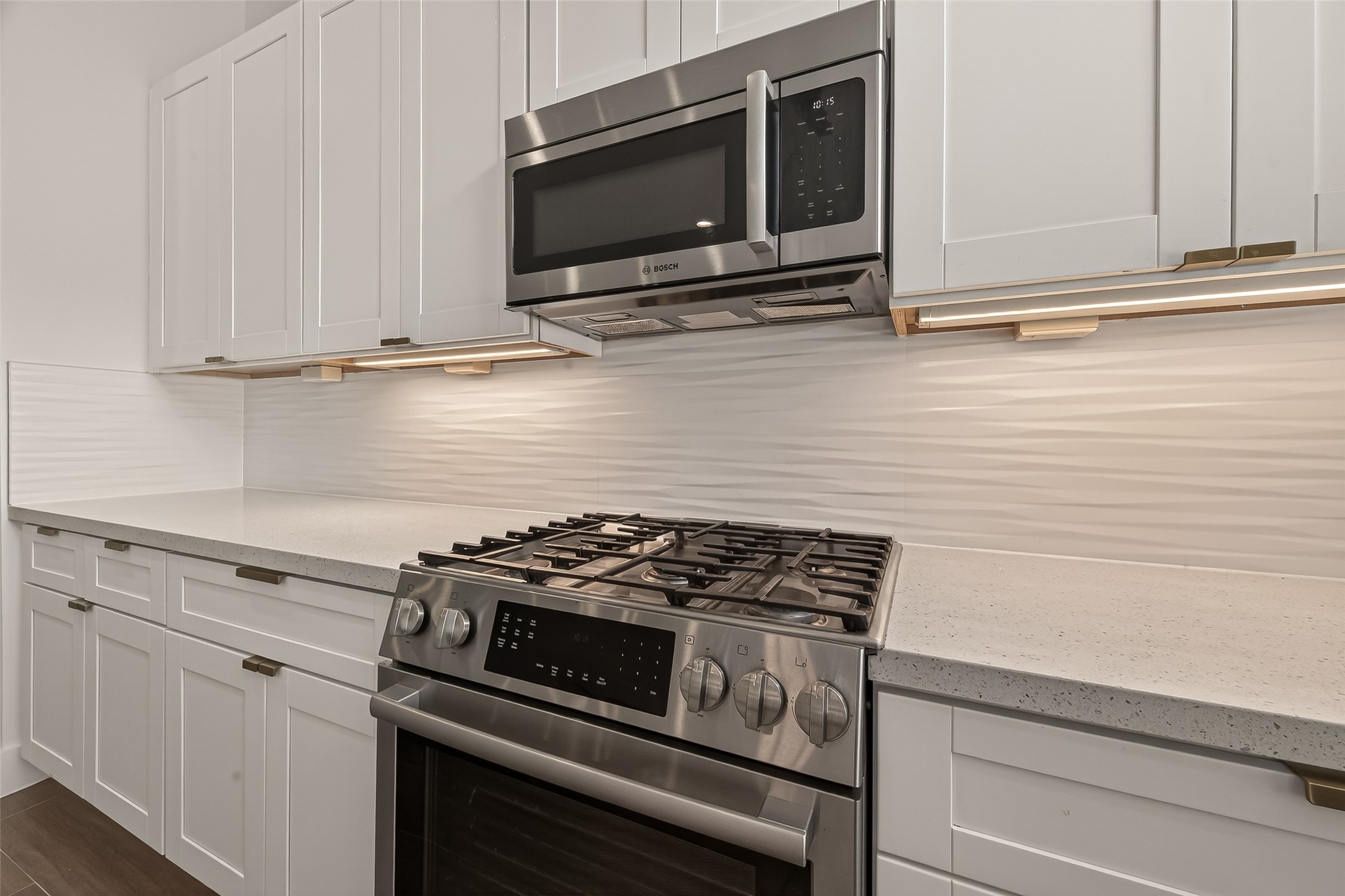 5505 Robusto Place Houston, TX 77091 - Photo 16 of 49 a kitchen with wooden cabinets and a stove top oven
