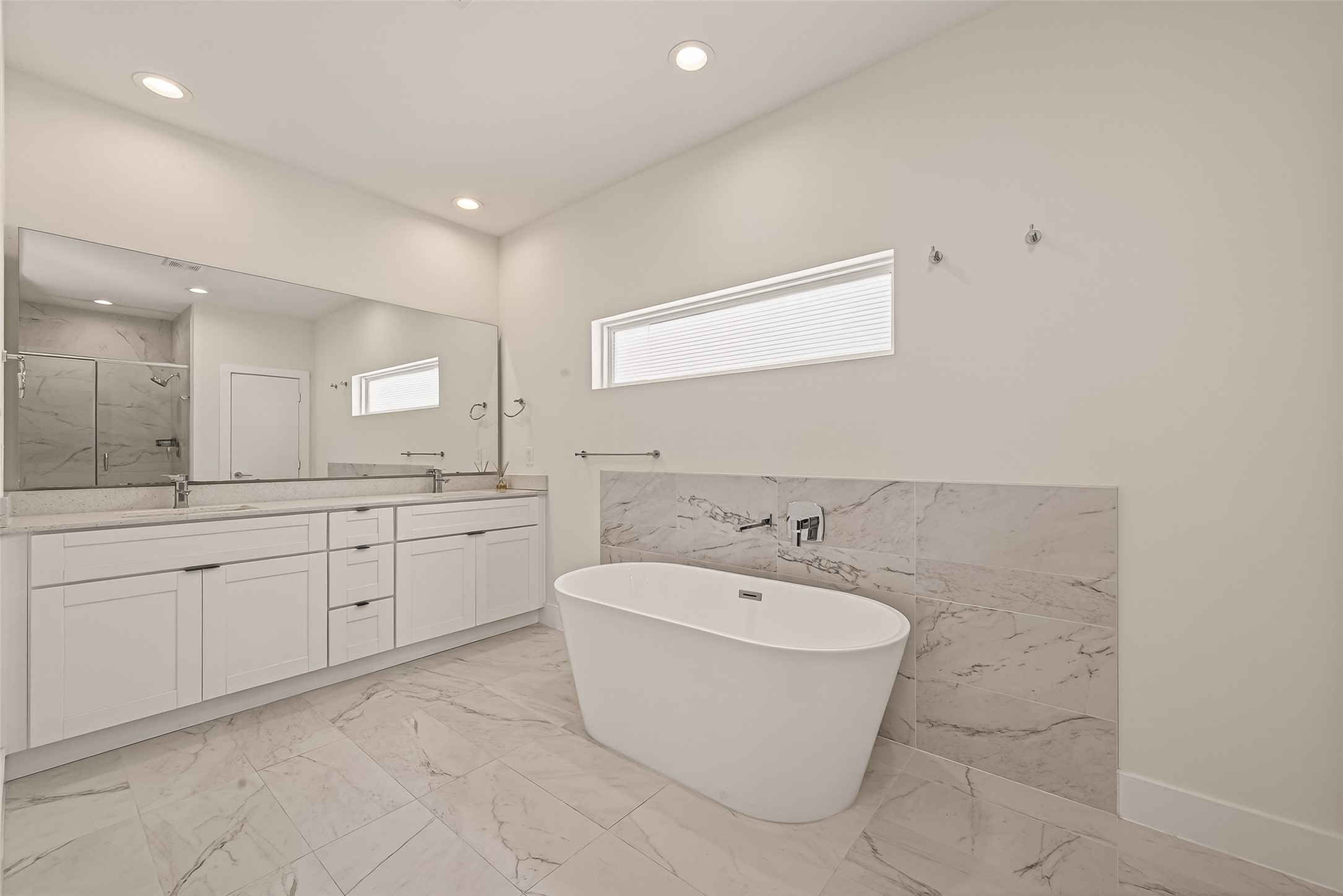 5505 Robusto Place Houston, TX 77091 - Photo 34 of 49 a spacious bathroom with a double vanity sink mirror and bathtub