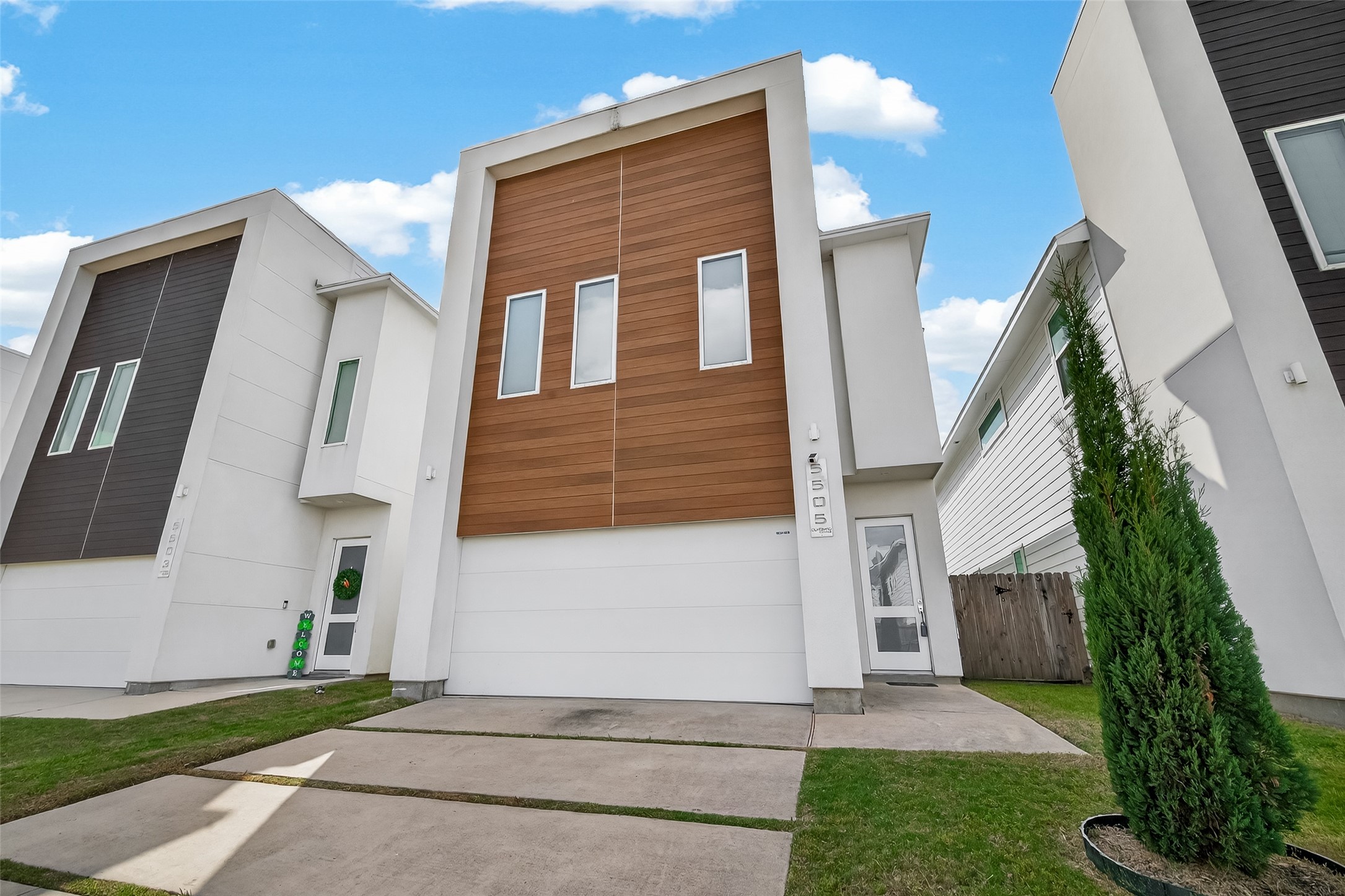 5505 Robusto Place Houston, TX 77091 - Photo 4 of 49 a front view of a house with a yard and garage