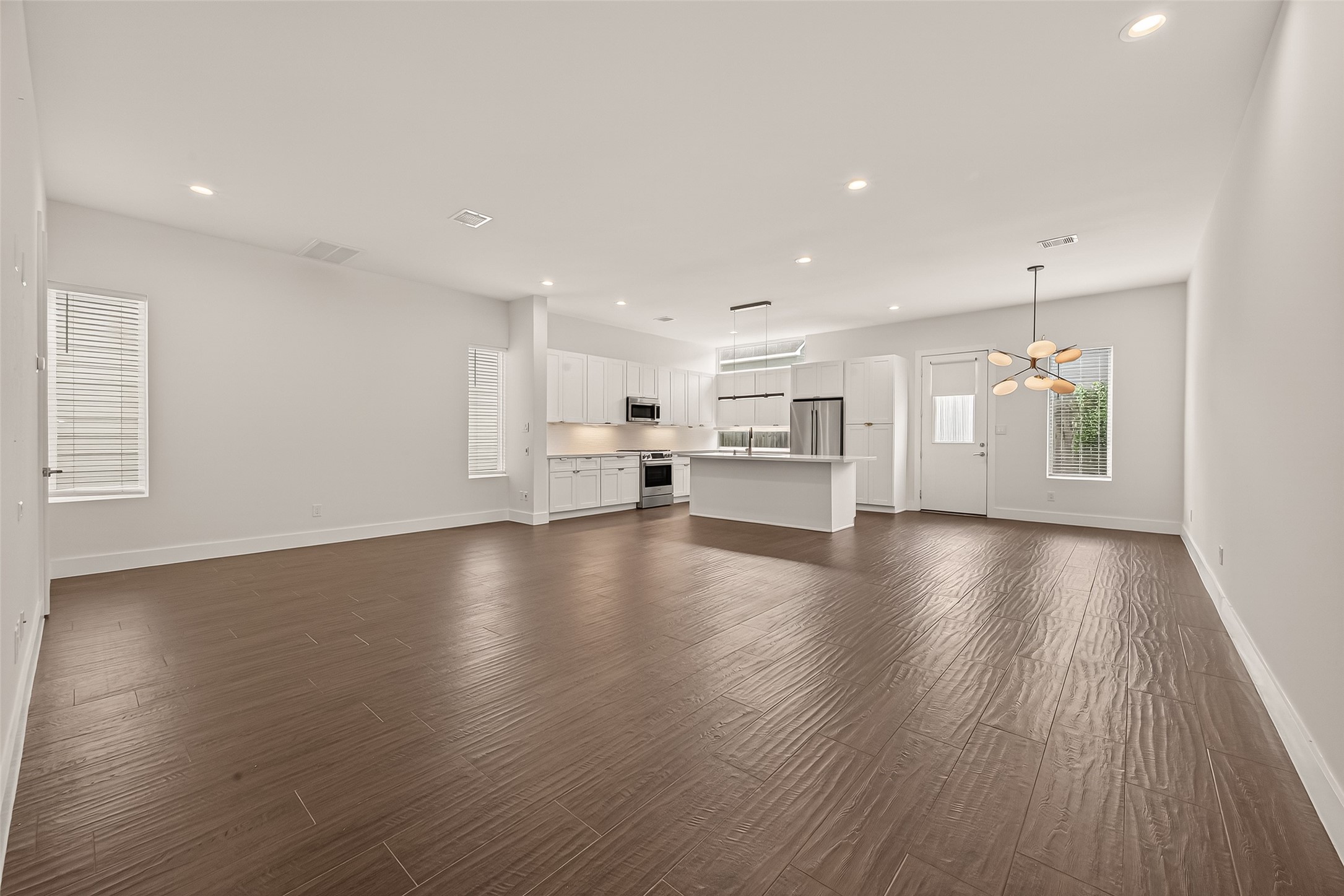 5505 Robusto Place Houston, TX 77091 - Photo 7 of 49 a view of empty room with kitchen and window