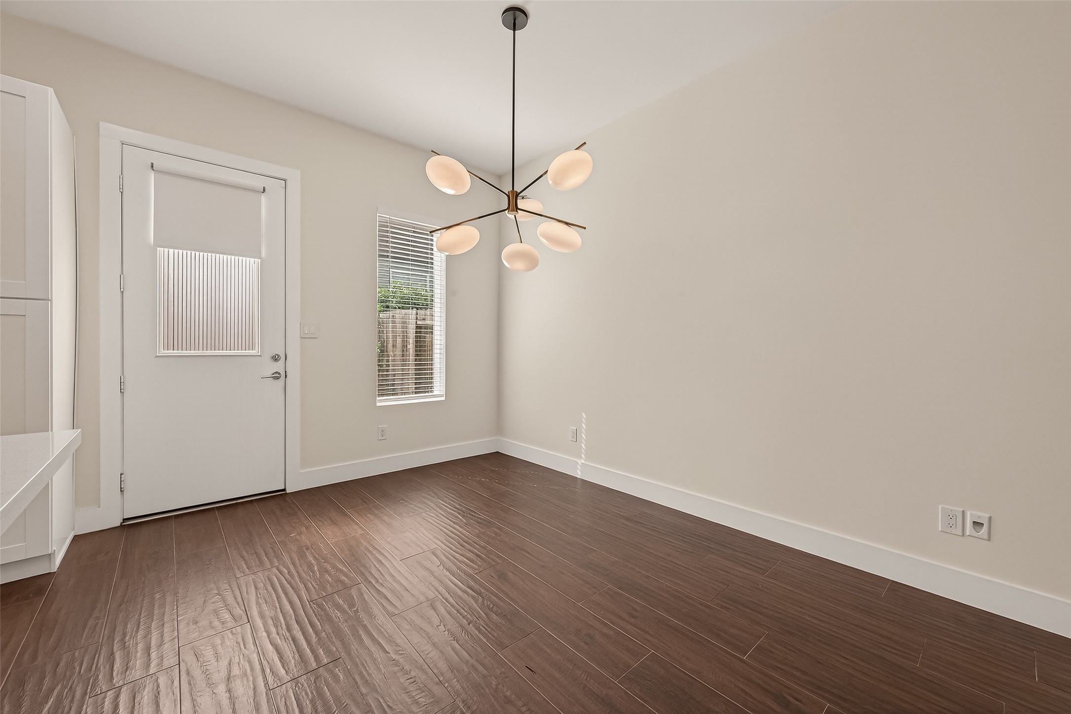 5505 Robusto Place Houston, TX 77091 - Photo 9 of 49 a view of an empty room with wooden floor and a window