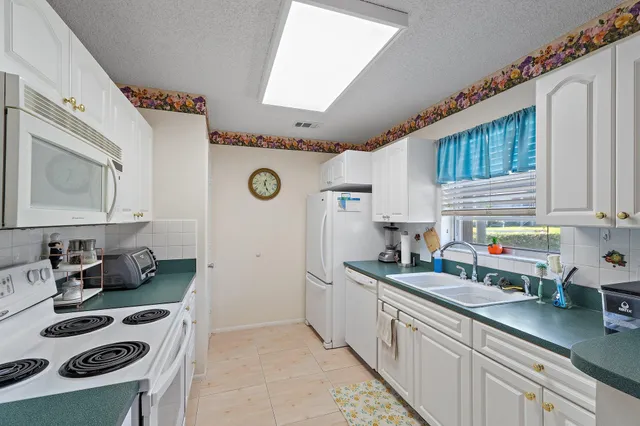 a kitchen with a sink a stove and cabinets