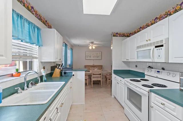 a kitchen with stove a sink and cabinets