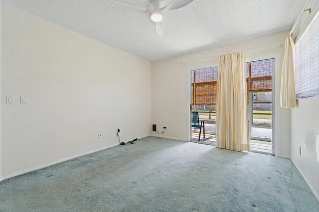 an empty room with closet and natural light