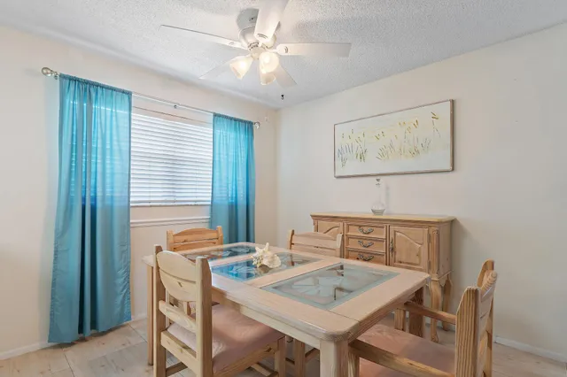 a view of a dining room that has a table and chairs