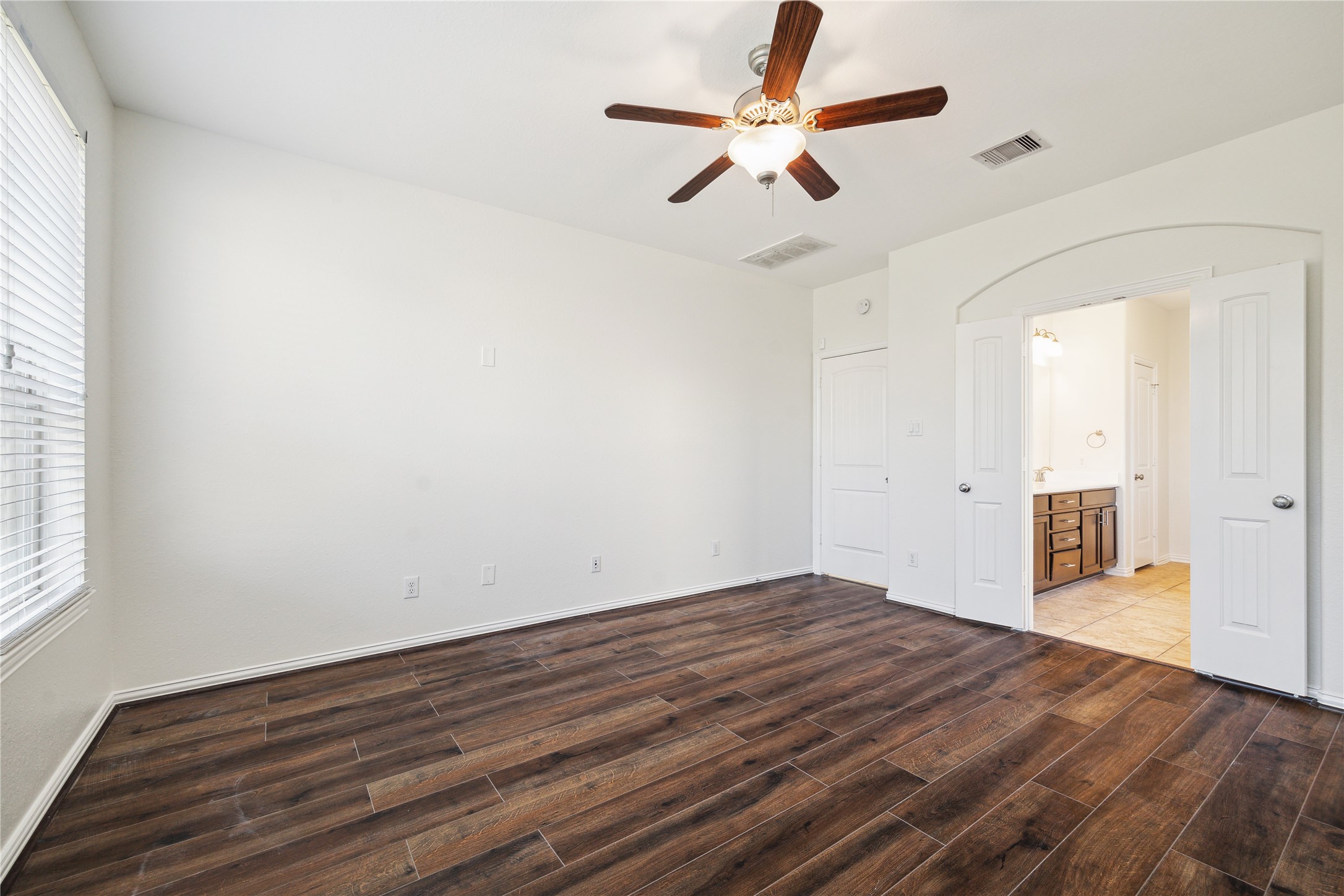 13108 Summit Harvest Lane Rosharon, TX 77583 - Photo 3 of 11 an empty room with wooden floor fan and windows
