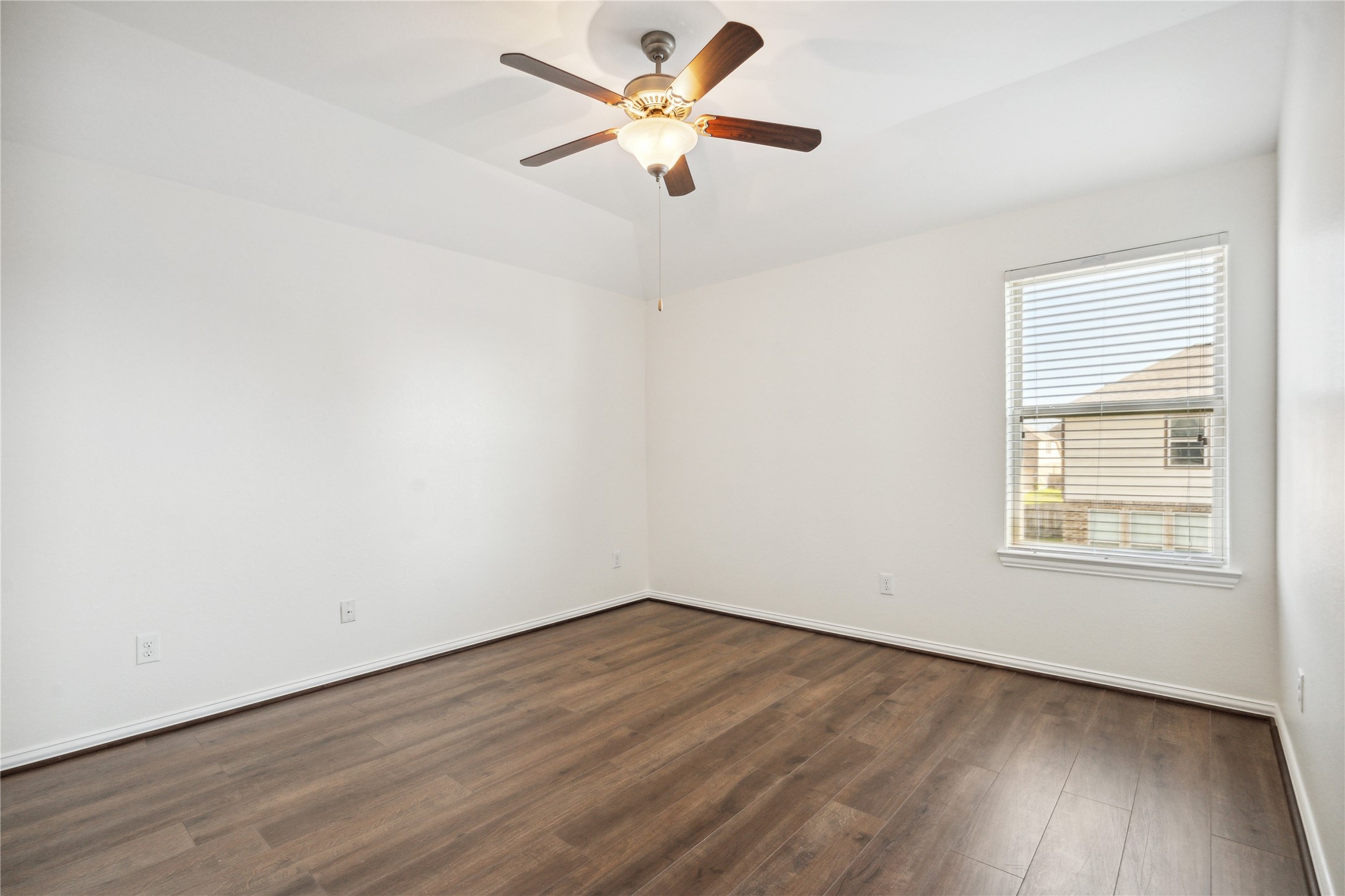 13108 Summit Harvest Lane Rosharon, TX 77583 - Photo 8 of 11 an empty room with wooden floor fan and windows