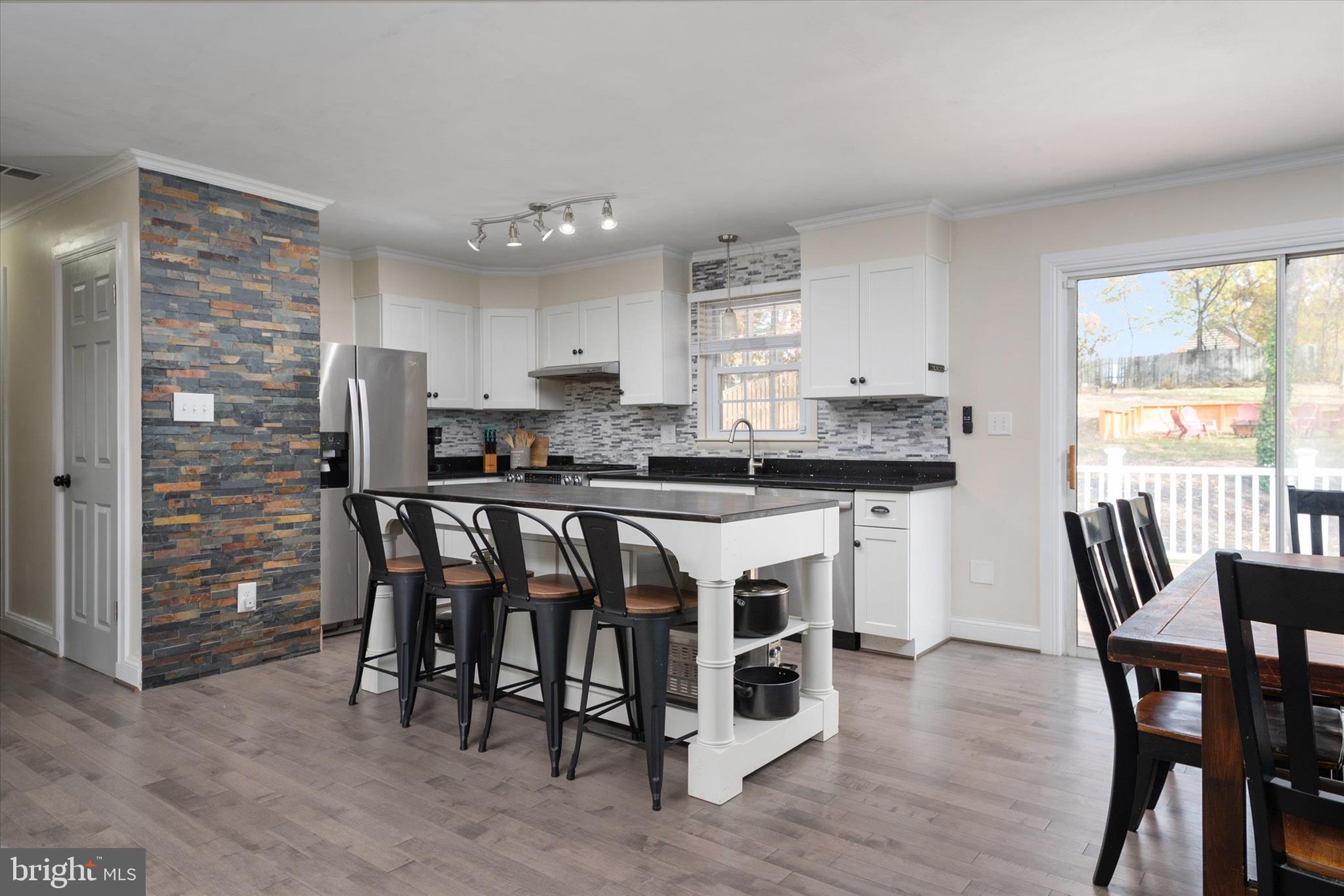 155 Barbara Road Severna Park, MD 21146 - Photo 6 of 51 a kitchen with stainless steel appliances granite countertop a stove a sink a microwave a dining table and chairs