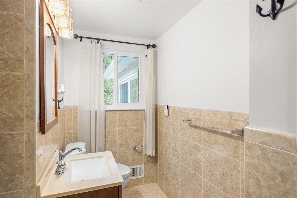 31 Livoli Road Framingham, MA 01701 - Photo 19 of 32 a bathroom with a sink a toilet and shower