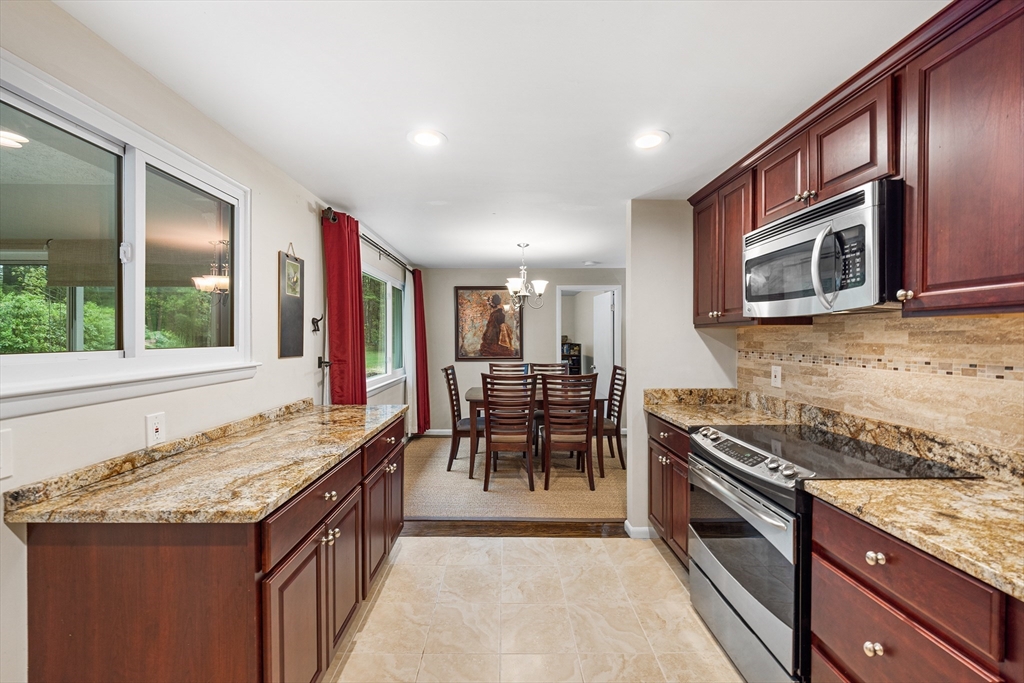 31 Livoli Road Framingham, MA 01701 - Photo 3 of 32 a kitchen with granite countertop cabinets stainless steel appliances and a counter space