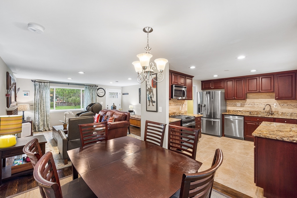 31 Livoli Road Framingham, MA 01701 - Photo 4 of 32 a living room with kitchen view and a dining table