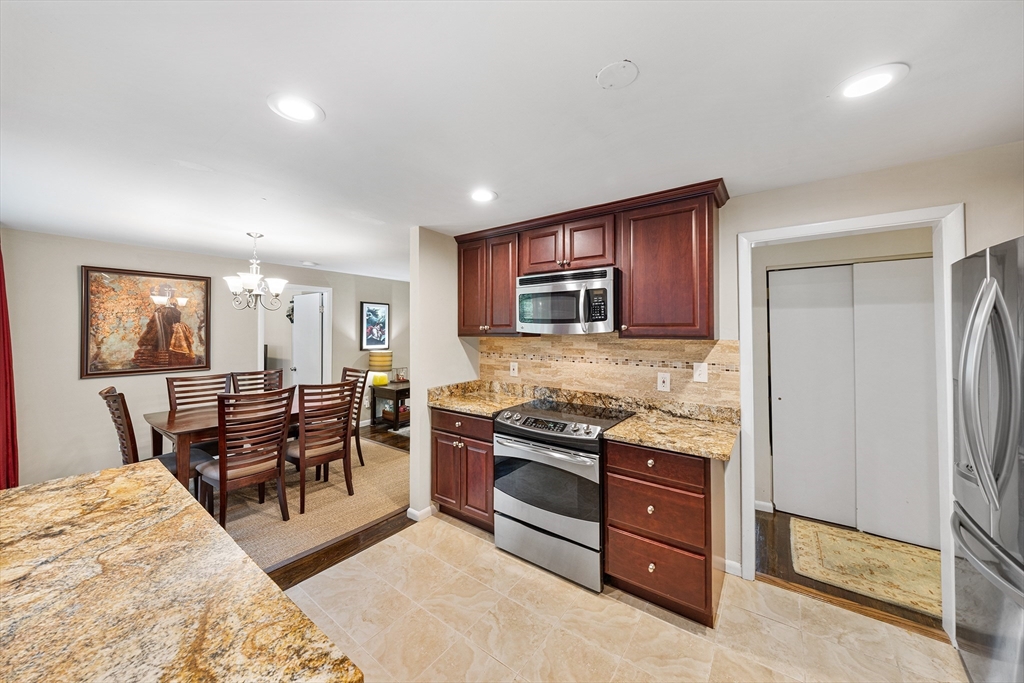 31 Livoli Road Framingham, MA 01701 - Photo 5 of 32 a kitchen with stainless steel appliances granite countertop a stove and a refrigerator