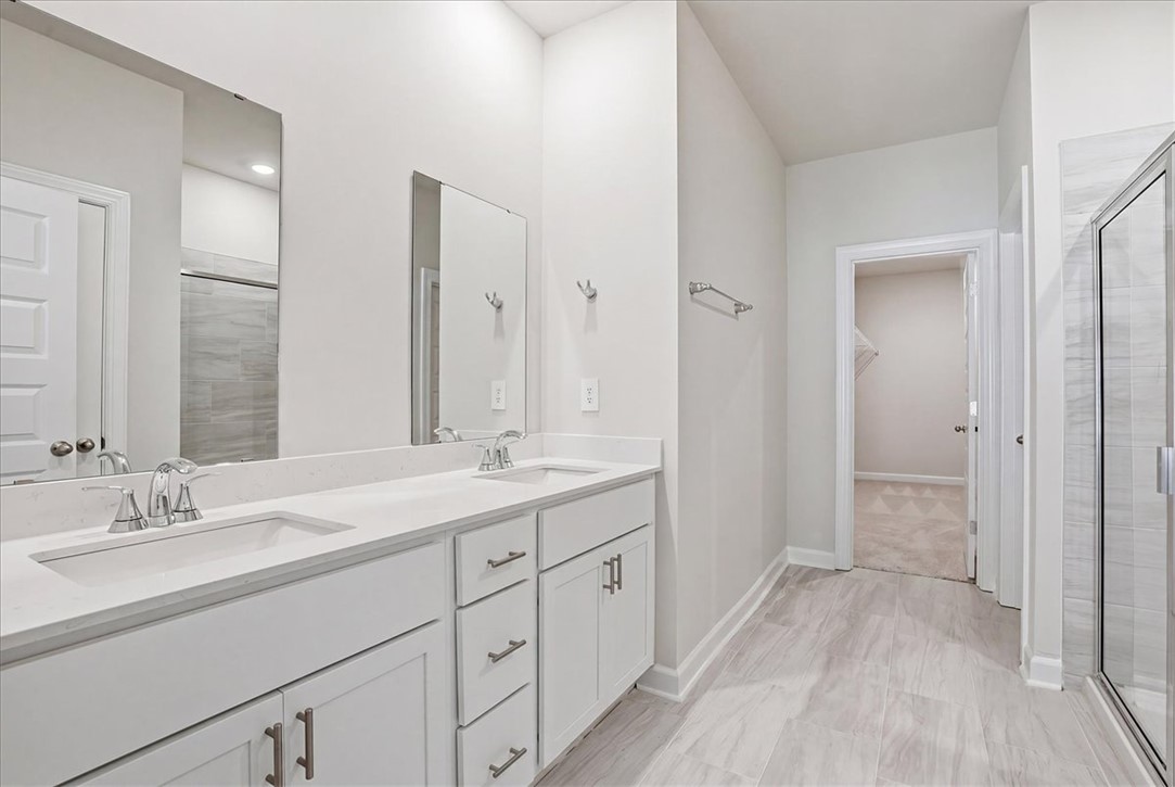 973 Penfold Pointe Point Blythewood, SC 29016 - Photo 19 of 39 This primary bathroom features a dual vanity with ample counter space and a modern glass-enclosed shower.