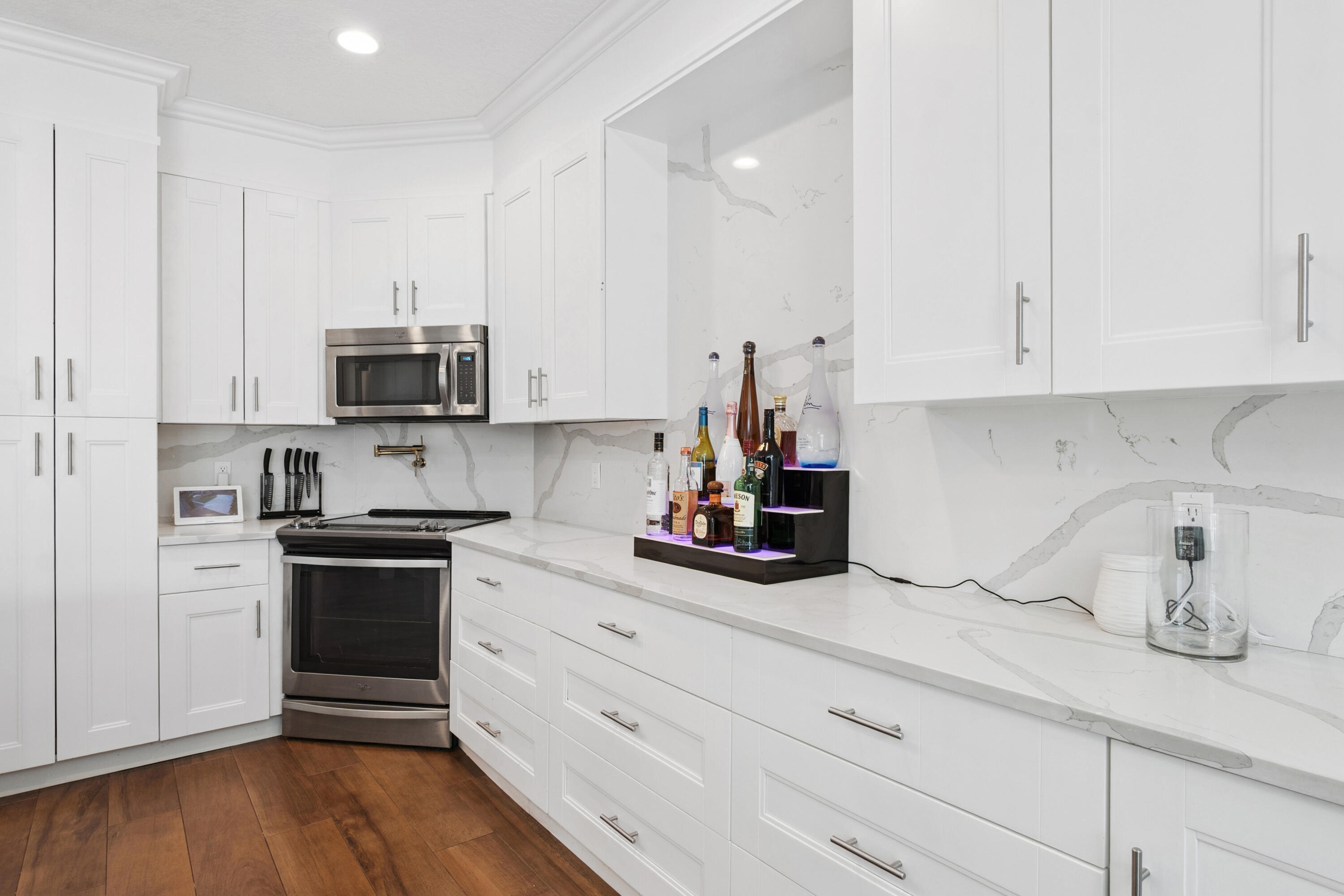 7110 Northwest Turtle Walk Boca Raton, FL 33487 - Photo 23 of 36 a kitchen with appliances a sink and cabinets