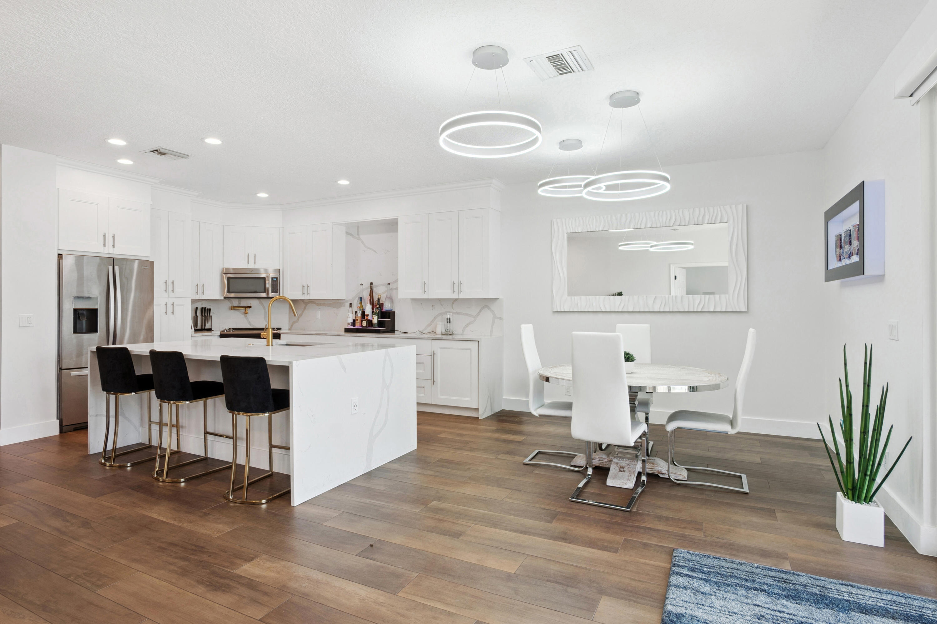 7110 Northwest Turtle Walk Boca Raton, FL 33487 - Photo 27 of 36 a living room with furniture and a dining table with kitchen view