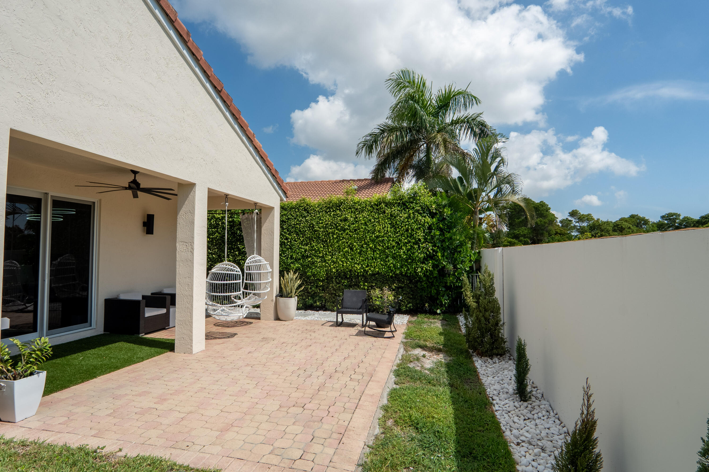 7110 Northwest Turtle Walk Boca Raton, FL 33487 - Photo 32 of 36 a balcony with potted plants and a big yard