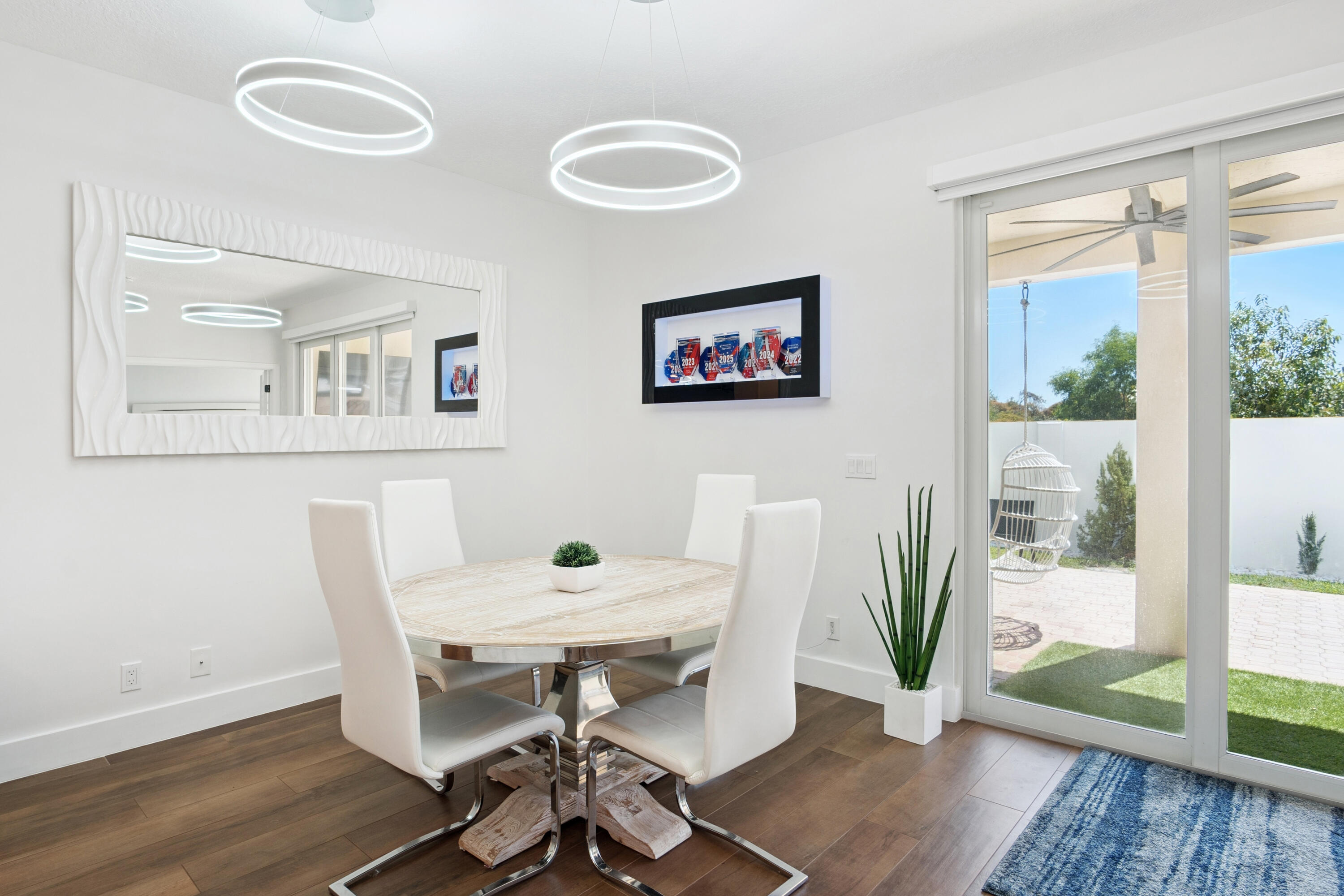 7110 Northwest Turtle Walk Boca Raton, FL 33487 - Photo 7 of 36 a view of a dining room with furniture and wooden floor