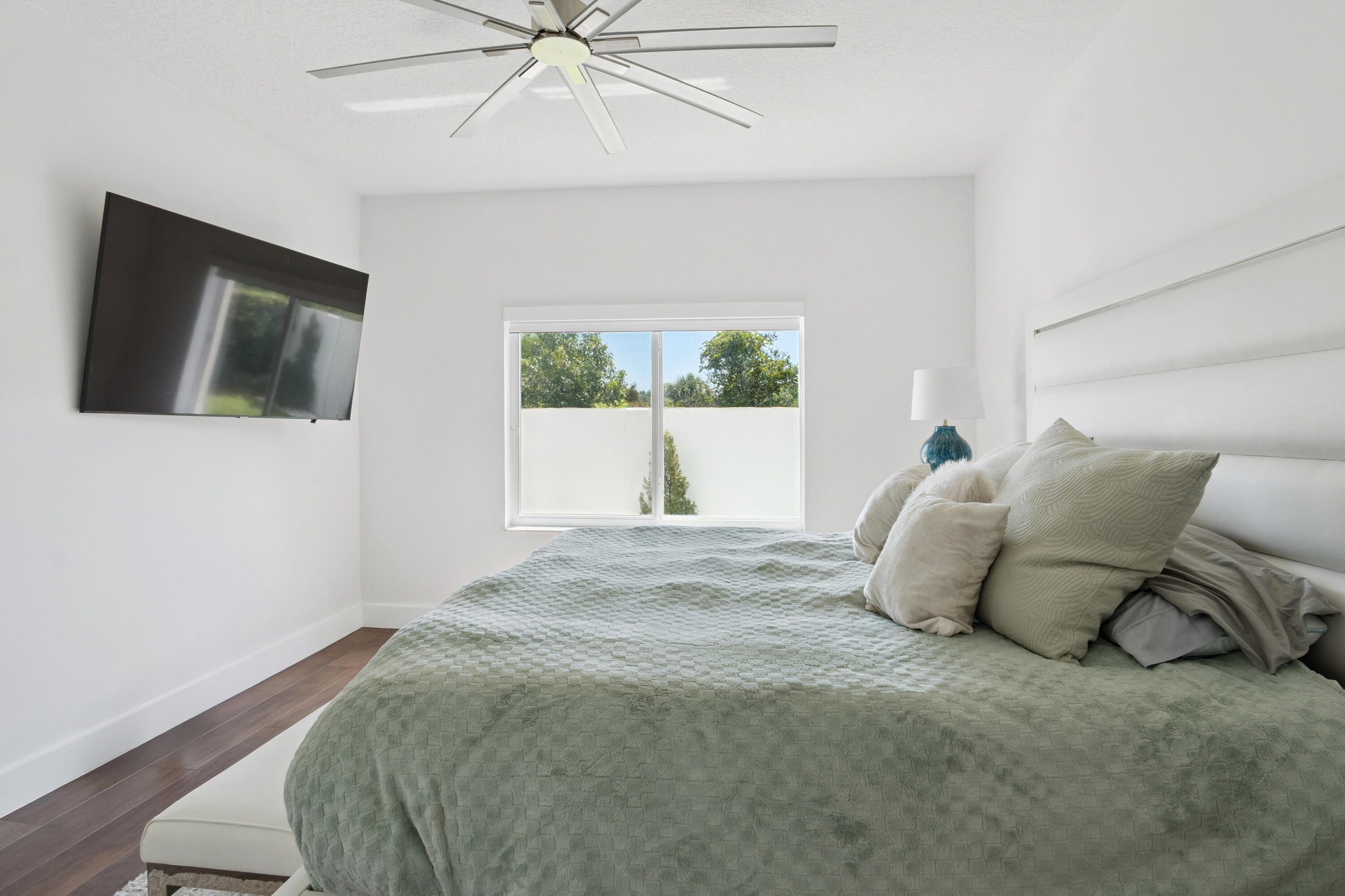 7110 Northwest Turtle Walk Boca Raton, FL 33487 - Photo 10 of 36 a bed sitting in a bedroom next to a window