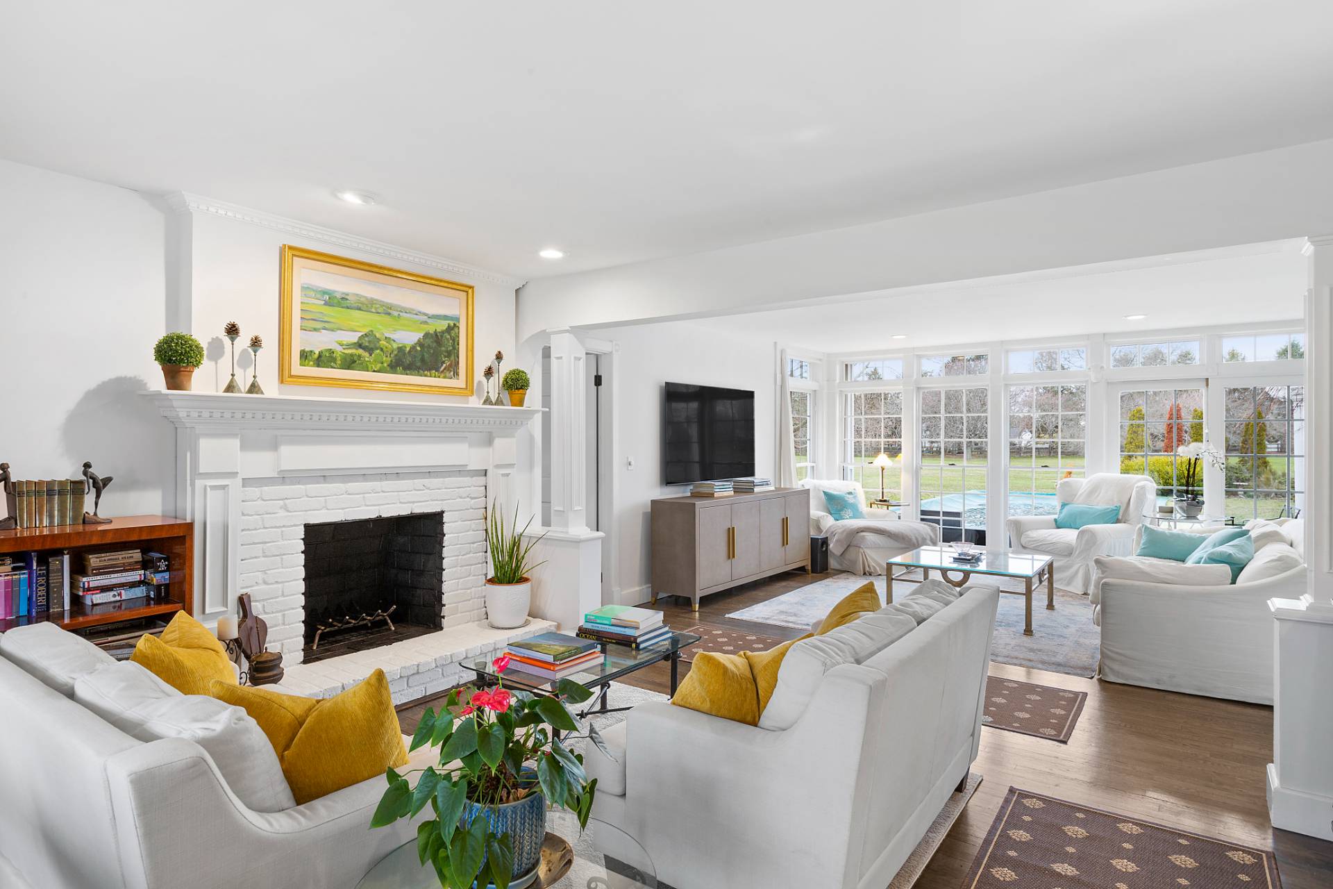 a living room with furniture fireplace and a large window
