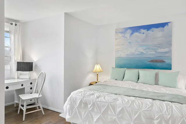 a bedroom with a bed and a chair