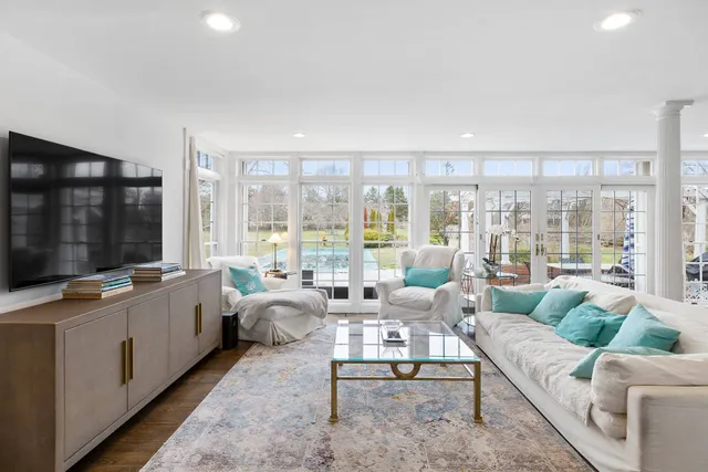 a living room with furniture and large windows