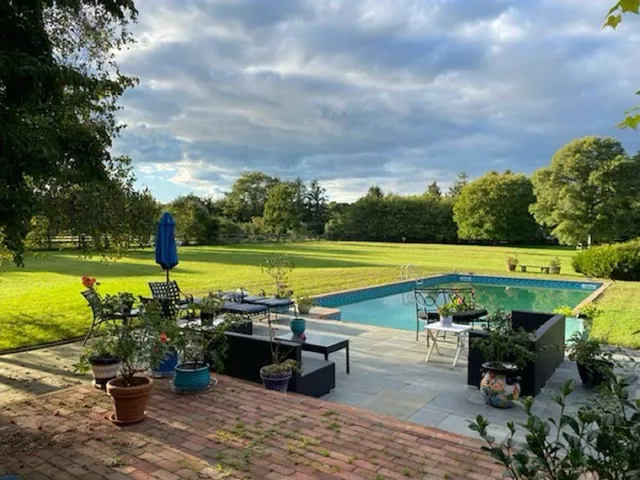 an outdoor space with furniture and garden