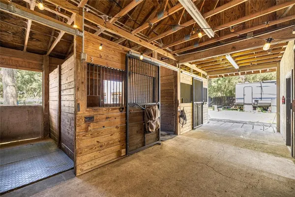 a view of grassy field with benches and trees all around
