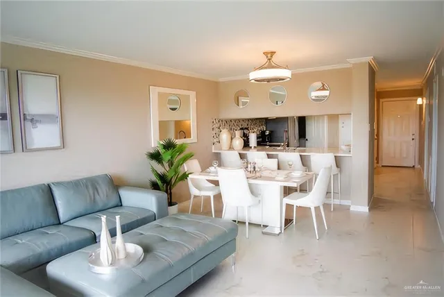 a living room with furniture a chandelier and a dining room