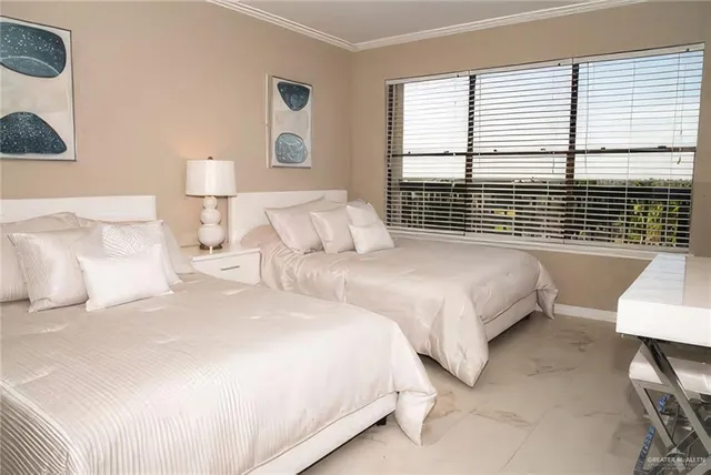 a bedroom with two beds and a large window