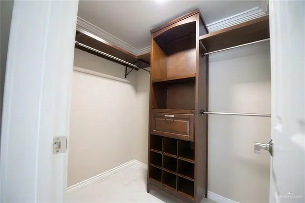 a view of walk in closet with empty racks