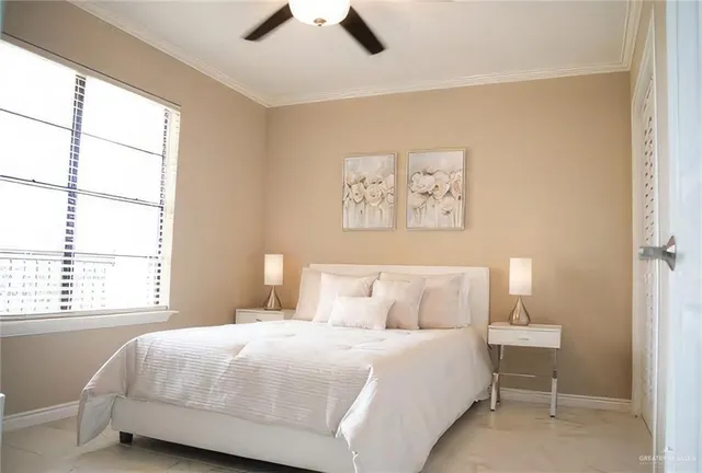 a bedroom with a bed and a window