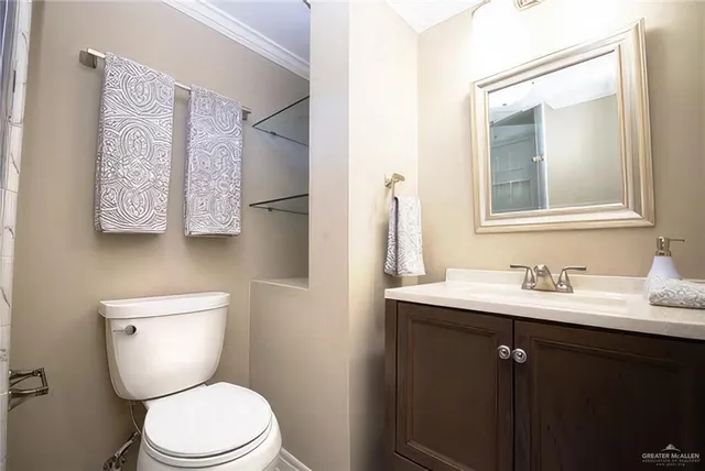 a bathroom with a toilet a sink and mirror