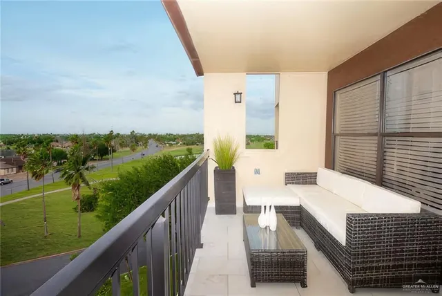 a balcony with wooden floor and city view