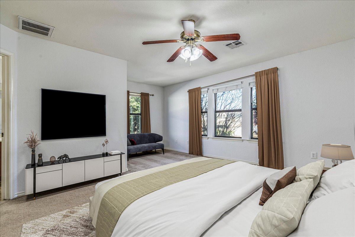 8700 Wiley Way Austin, TX 78747 - Photo 14 of 26 Large primary bedroom and sitting area.
