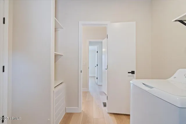 a view of empty room with wooden floor