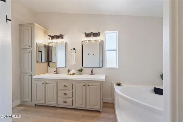a spacious bathroom with a sink and a mirror