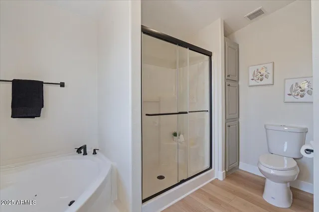 a big house with a large tree and wooden fence