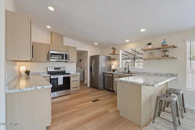 a kitchen with a sink stove and refrigerator