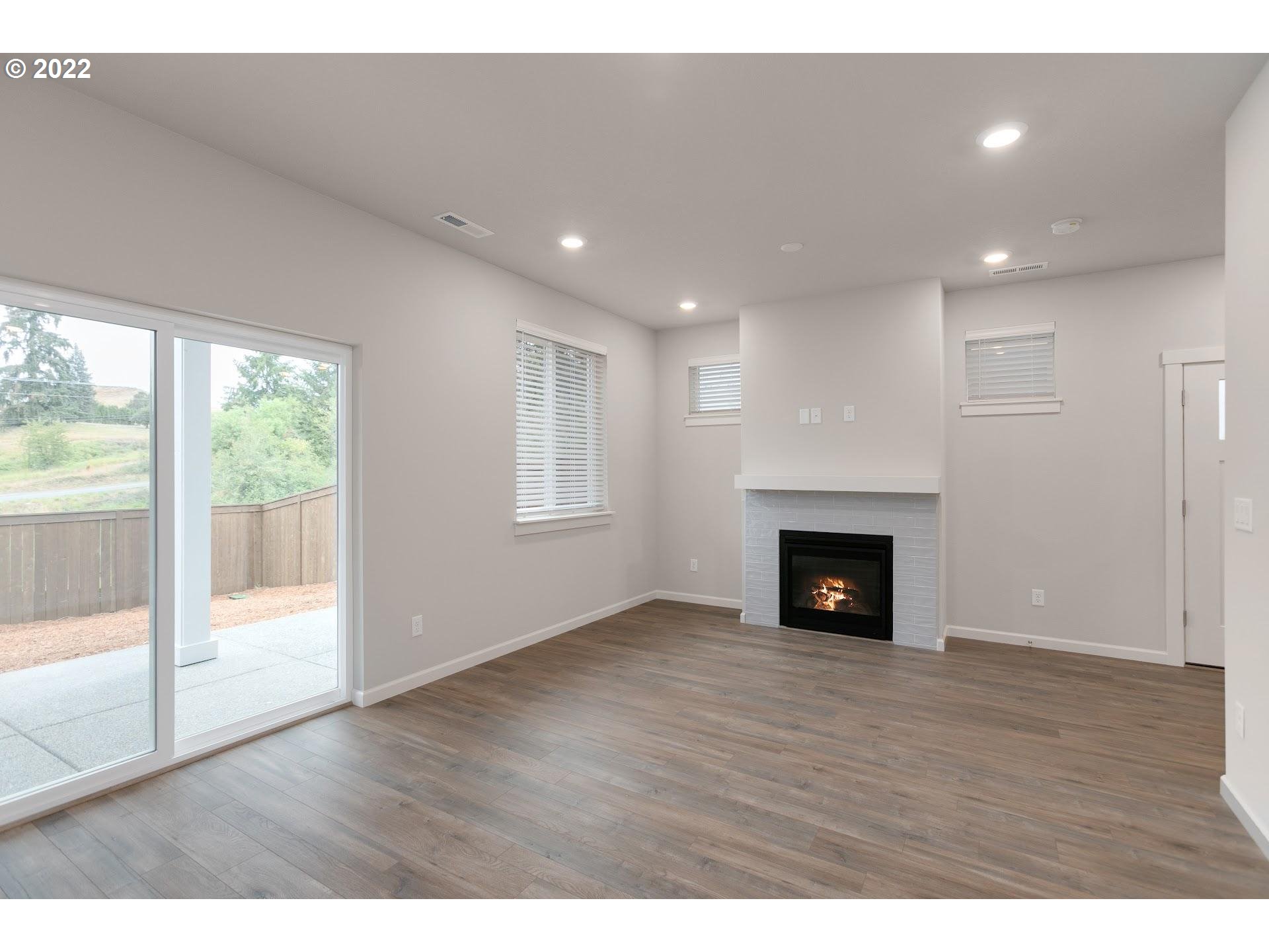 4232 South Cloverhill Way Ridgefield, WA 98642 - Photo 12 of 30 a view of an empty room with wooden floor and a window