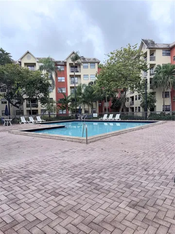 a view of a park with a slide and plants