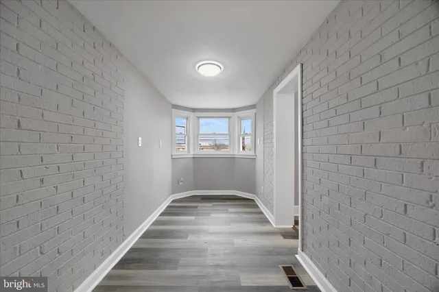 a view of an empty room with a ceiling fan