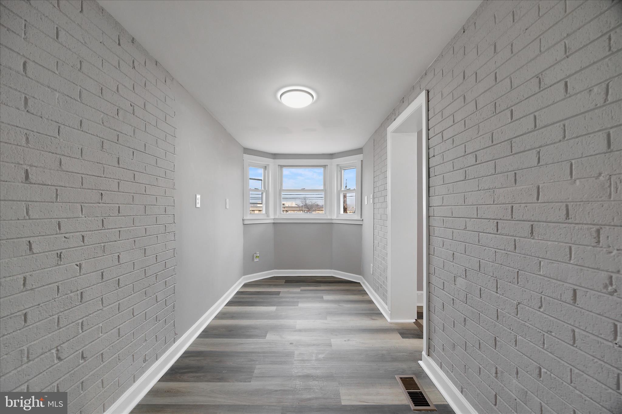 4007 Forestville Road District Heights, MD 20747 - Photo 18 of 45 a view of a hallway with wooden floor and a bathroom