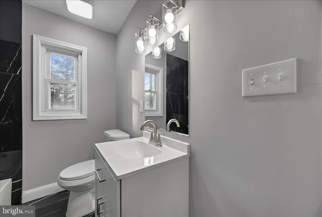a kitchen with a refrigerator and a stove top oven