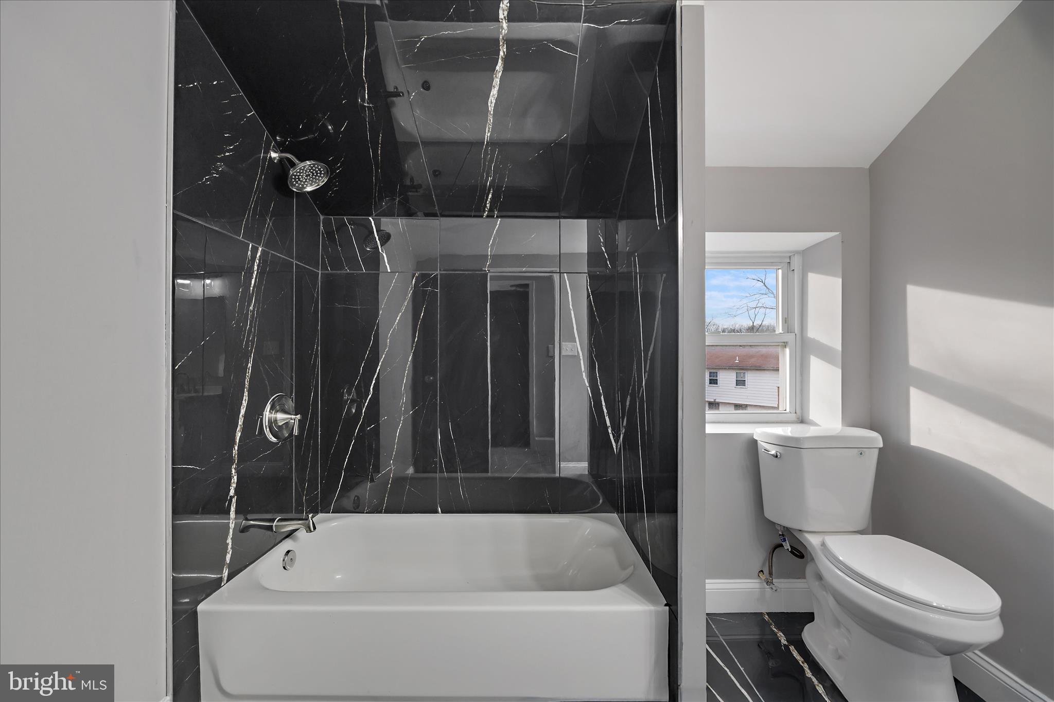 4007 Forestville Road District Heights, MD 20747 - Photo 25 of 45 a bathroom with a shower a toilet and a sink