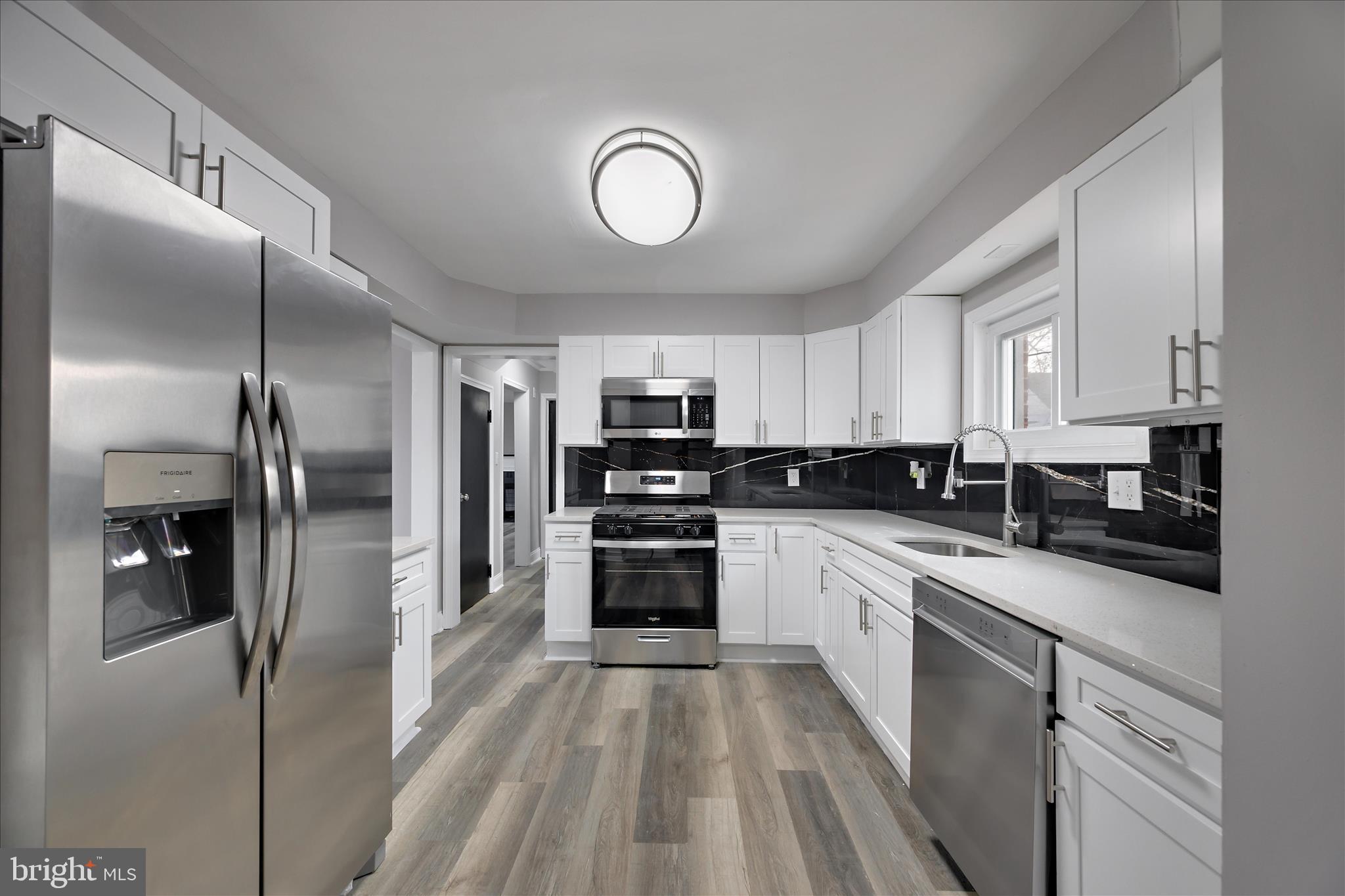 4007 Forestville Road District Heights, MD 20747 - Photo 3 of 45 a large kitchen with cabinets stainless steel appliances and a center island