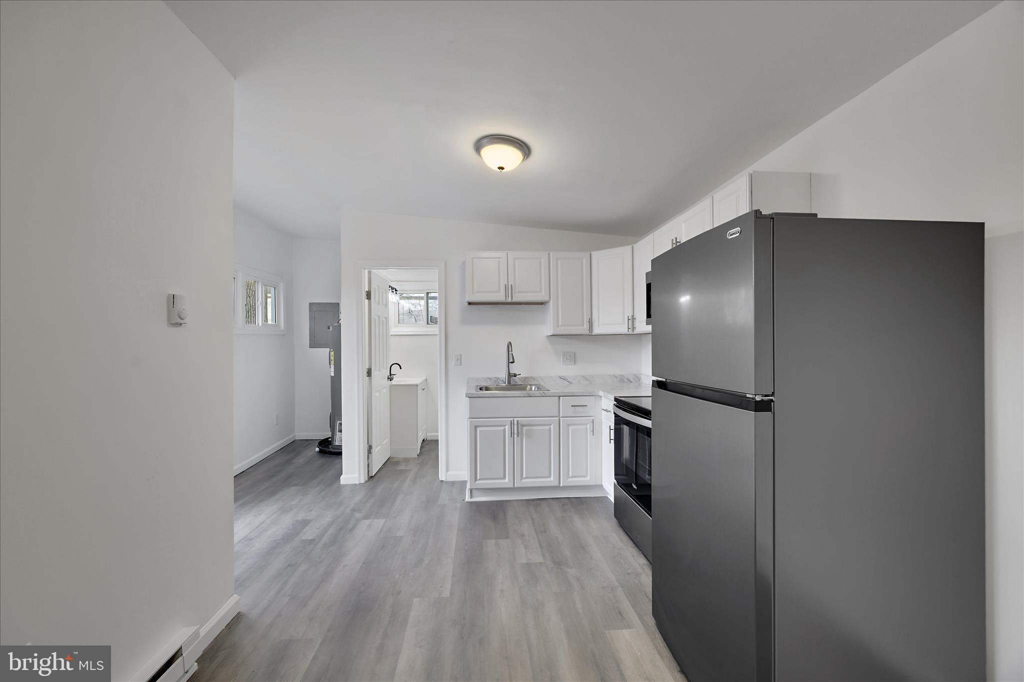 4007 Forestville Road District Heights, MD 20747 - Photo 38 of 45 a kitchen with a refrigerator and a stove top oven