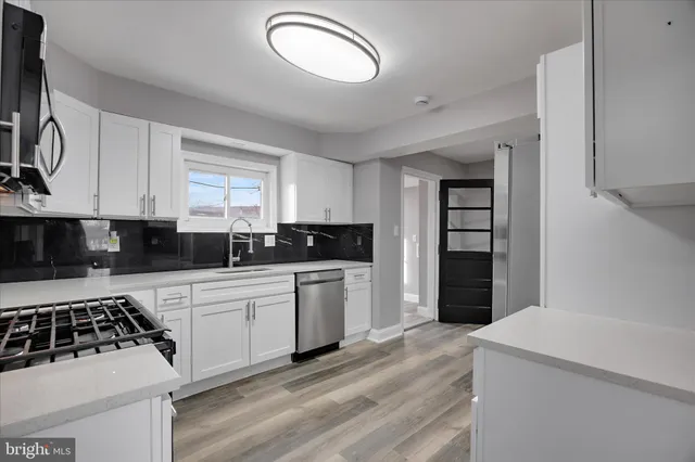 a view of a hallway with wooden floor and closet