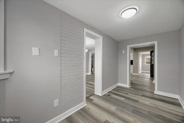 a view of an empty room with a fireplace and a window